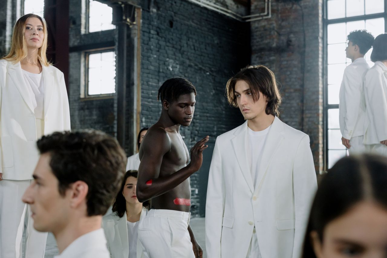 Services-01 Models in a fashion shoot wearing white outfits in an industrial space.