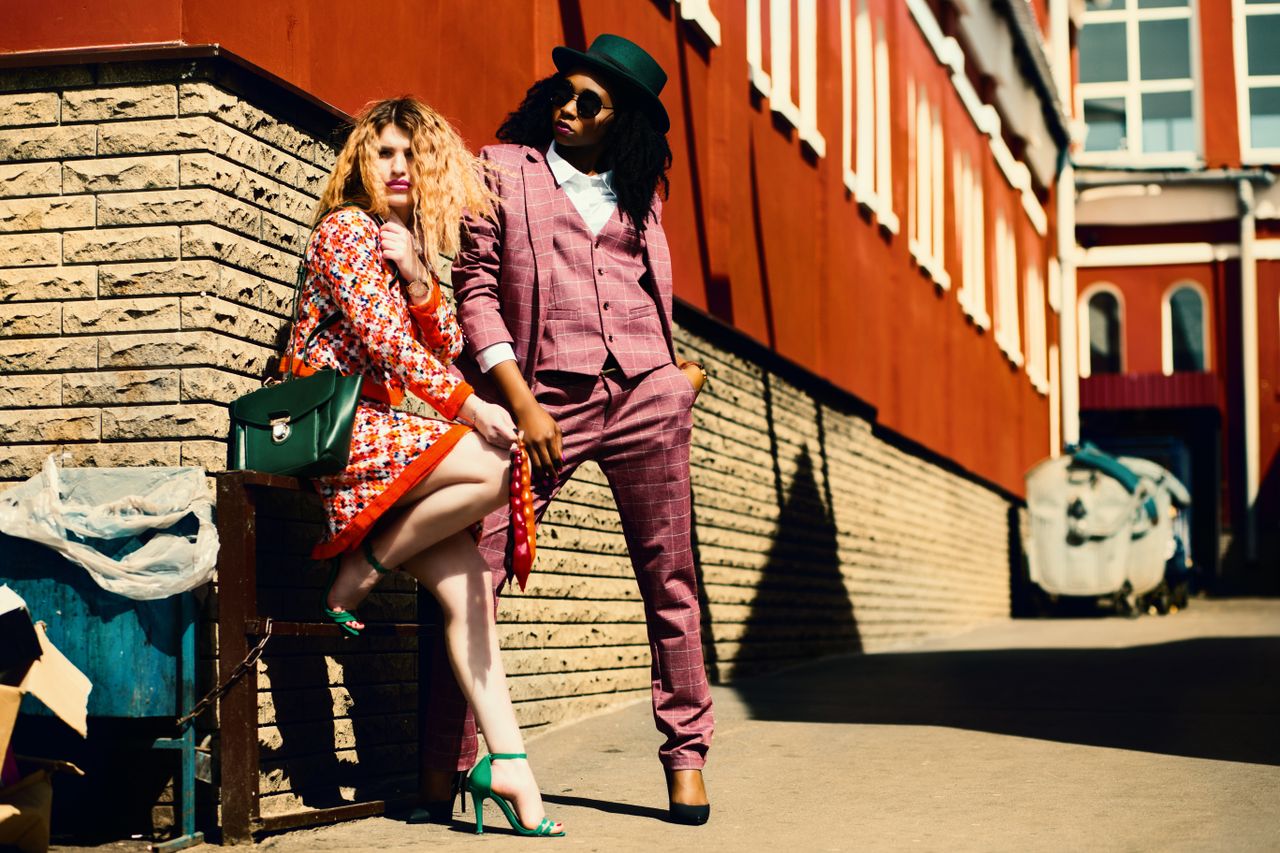 Services-03 Fashionable duo posing outdoors in vibrant outfits, embracing urban style and confidence.